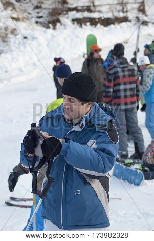 young man in ski jacket and smartfon