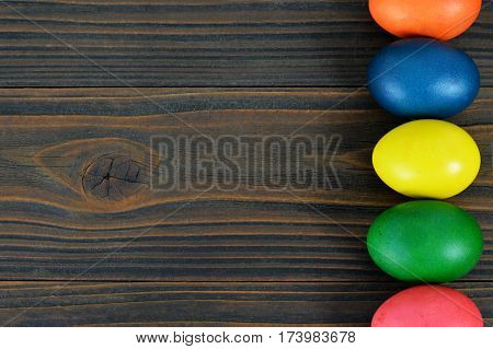 Easter wooden background with colorful Easter eggs