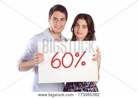 Portrait of a young beautiful couple holding cardboard with "60%". Isolated white background.