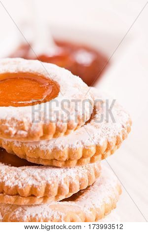 Tea time biscuits with cinnamon tea on white dish.