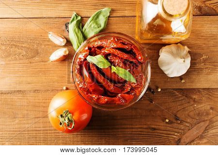 Italian appetizer - sundried tomato in bowl on the wooden table.