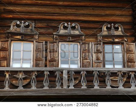 Three Windows With Carved Platbands On Wooden House, Russian