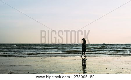 Single Young Woman On Beach When Sunset