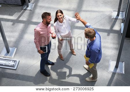 Top View Of Young Modern Colleagues In Smart Casual Wear Working Together While Spending Time In The