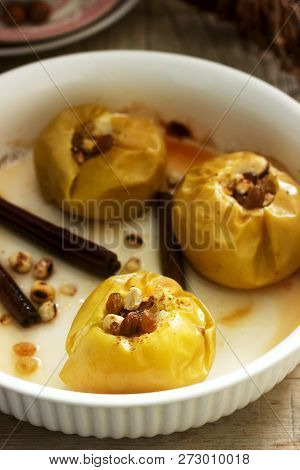 Baked Apples With Raisins, Hazelnuts And Cinnamon On Wooden Background. Rustic Style.