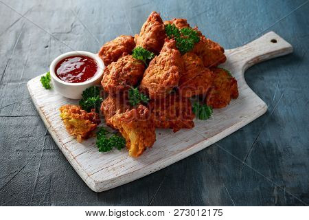 Crispy Onion Bhajis With Sweet Chilli Sauce On White Wooden Board
