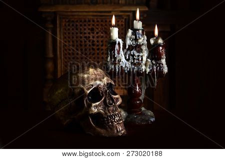 Old Battered Skull Lies With An Antique Wooden Candlestick