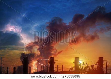 Hemical Factory Plant And Oil Refinery Industry With Sunrise. Dramatic Sky And Lightning