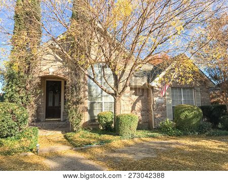 Beautiful Entrance To Typical House With American Flag And Colorful Autumn Leaves