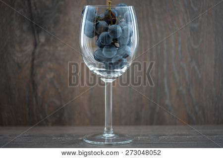 A Wine Glass With Sweet Black Grape Varietal