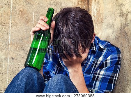 Sad Teenager In Alcohol Addiction With A Beer