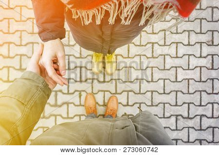 First Person View Of Couple Holding Hands. Loving Couple Holding Hands While Walking At Sunset. Apol
