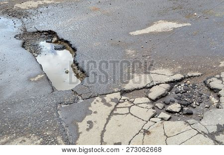 Bad Road. Broken Asphalt In Khimki, Moscow Region