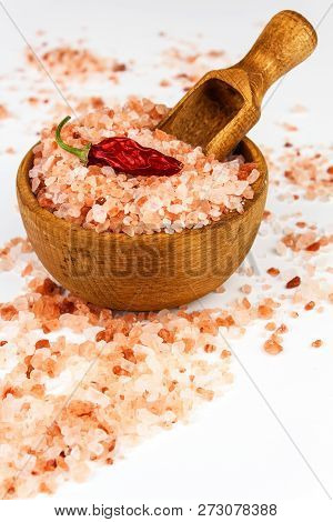 Pink Salt From The Himalayas On White Background. Pile Of Pink Himalayan Salt. Salt And Chilli Peppe