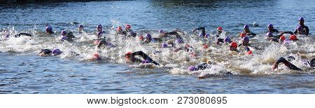 St Neots, Cambridgeshire, England - July 01, 2018:  Triathlon Swimmers In The River Ouse At St Neots