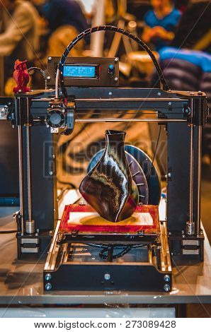 3d Printer Printing A Model In The Form Of Black Vase Close-up.