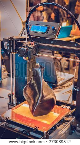 3d Printer Printing A Model In The Form Of Black Vase Close-up.