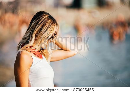 Beautiful Young Woman In Sunglasses On The Beach