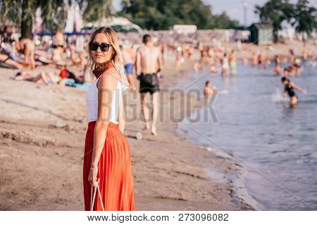 Pretty Young Woman With Sunglasses On The Beach