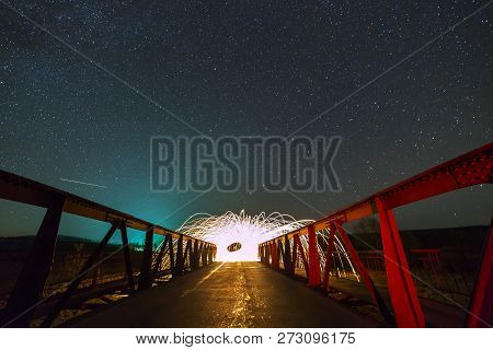 Light Painting Art Concept. Long Exposure Shot Of Spinning Steel Wool In Abstract Circle Making Fire
