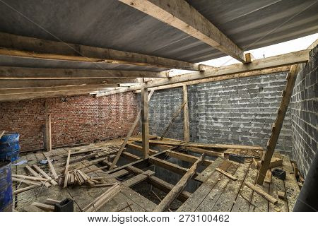 Spacious Attic Room Under Construction And Renovation. Energy Saving Walls Of Large Hollow Foam Insu