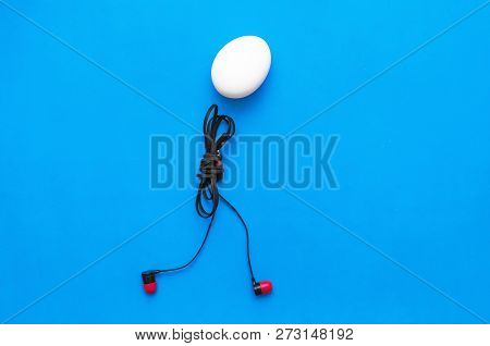 Chicken Egg With Headphones Body Is Walking On The Blue Background.
