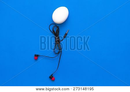 Chicken Egg With Headphones Body Is Walking On The Blue Background.