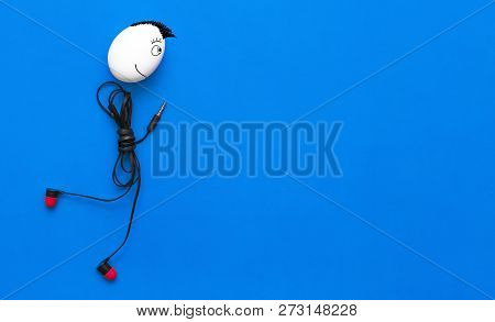 Chicken Egg Man With Iroquois On His Head With Headphones Body Is Walking On The Blue Background.