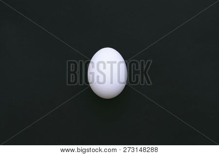 White Chicken Egg Isolated On A Black Background.