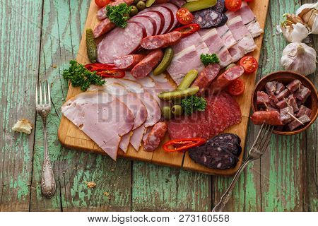 Charcuterie Board With Sausages And Smoked Meat. Top View.