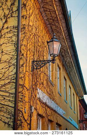 Street Lantern On House Corner With Plasterd Walls Outdoors On Yellow Background. Light, Lighting, I