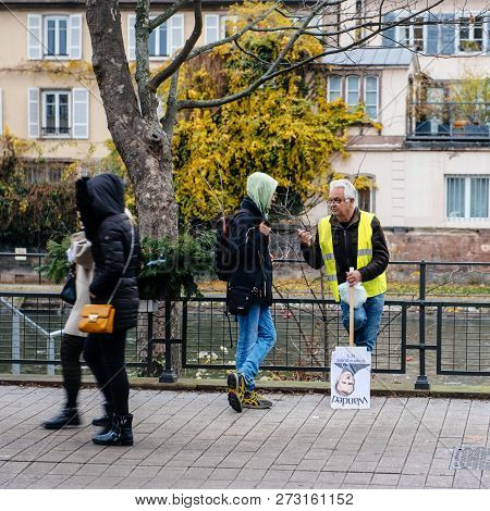 Strasbourg, France - Dec 8, 2018: Man With Emmanuel Macron Palcard And Text Wanted Talking With Pede
