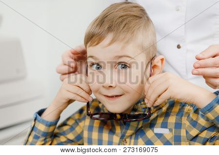 Ophthalmologist Tests Child Kid Boy For Color Blindness, Eye Vision Test.