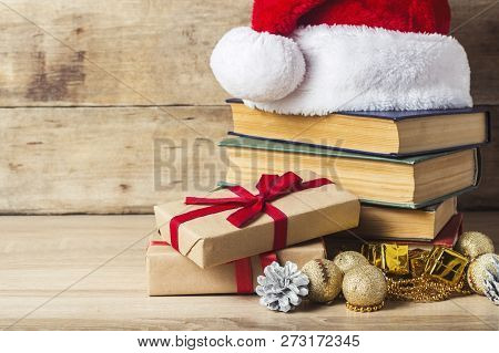 A Stack Of Books, Santa Clauss Cap, An Alarm Clock, Cones, Christmas-tree Decorations, Gift Boxes On