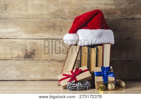 A Stack Of Books, Santa Clauss Cap, An Alarm Clock, Cones, Christmas-tree Decorations, Gift Boxes On