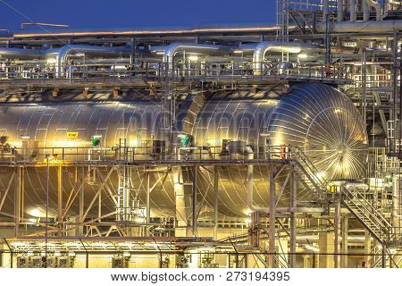 Giant Container In Chemical Factory At Night. Petrochemical Background.