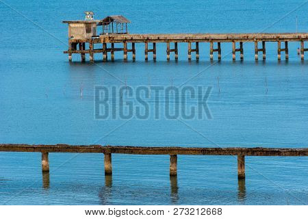Beach, Bridge And The Moon Is Rising At 
Nim Seng Beach, Songkhla, Thailand.