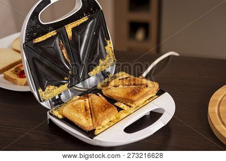 Detail Of Hot Sandwiches Ready For Eating In A Sandwich Maker. Selective Focus On The Sandwiches