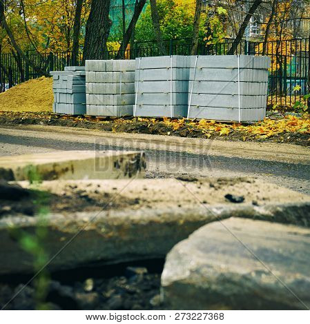 Freshly Dug Up Old Curbstones On The Foreground And New Ones Standing On The Background