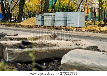 Freshly Dug Up Old Curbstones On The Foreground And New Ones Standing On The Background