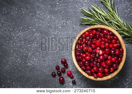 Cranberry And Rosemary On Black Stone Background. Ingredients For Cranberry Sauce Or Drinks. Top Vie