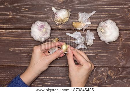 Woman Hands Are Spliting Garlic Cloves. Recipe Step By Step Baked Potatoes With Onion Flatlay On Bro