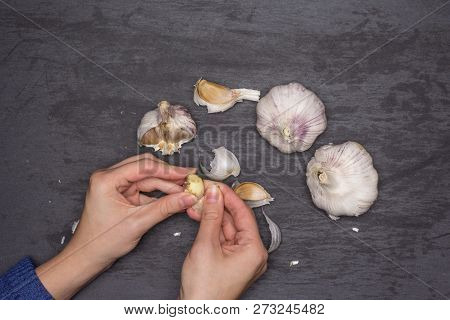 Woman Hands Are Spliting Garlic Cloves. Recipe Step By Step Baked Potatoes With Onion Flatlay On Gre