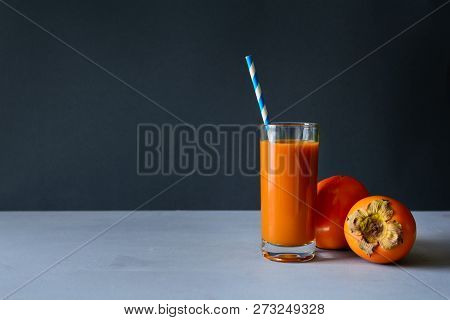 Persimmon Juice With Persimmons On Gray Wooden Background. Healthy Eating Concept. Coopy Space.