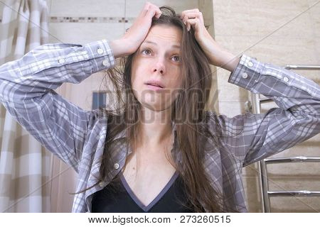 Sleepy Woman Who Has Just Woken Up With A Hangover In The Bathroom Try To Puts Herself In Order.