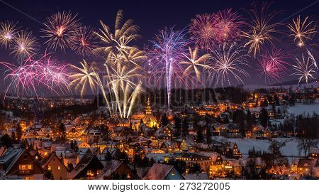 New Year Eve Firework And Illuminated Houses In Seiffen At Christmastime. Saxony Germany.
