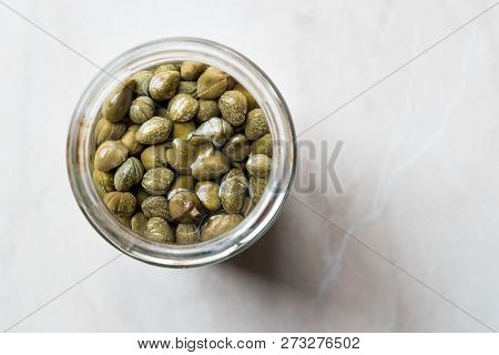 Jar Of Capers In Glass Bowl.