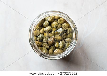 Jar Of Capers In Glass Bowl.