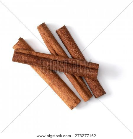 Cinnamon sticks isolated on white background closeup. Canella spice. Aromatic condiment background. Flat lay, top view.