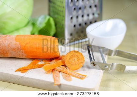 Fresh Carrot Grated On A Metal Kitchen Grate. Vegetables Prepared For Salad With A Meal On The Kitch